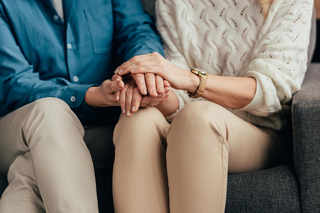 stock-photo-cropped-view-husband-wife-holding